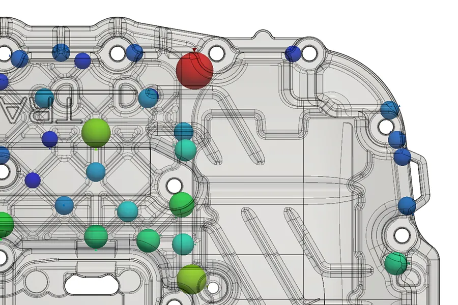 veo-Analyse: Materialanhäufungen als farbige Kugeln im transparenten CAD-Modell